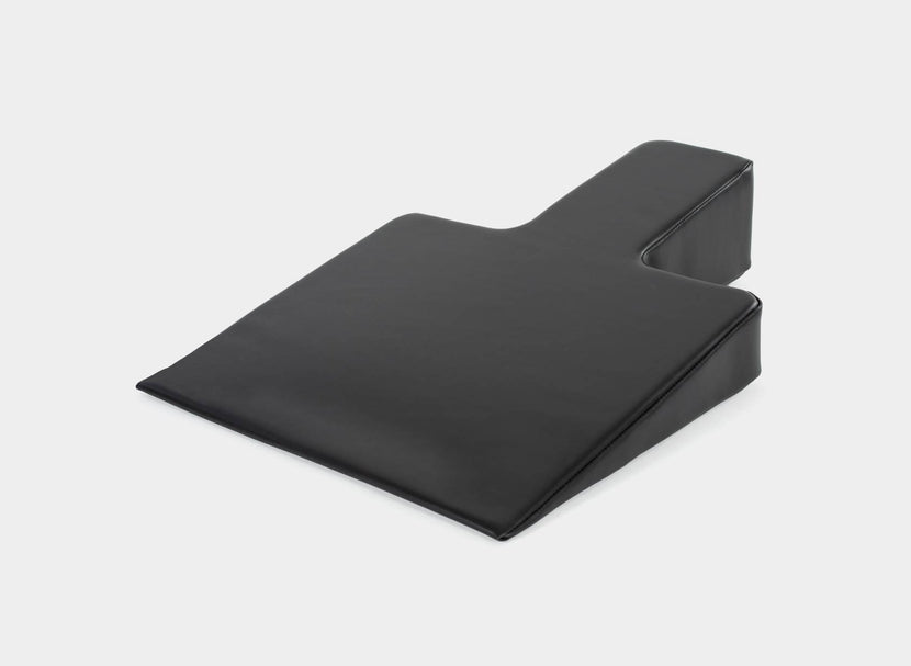 Black Pilates wedge for improved posture.